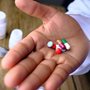 a doctors hand holding pills