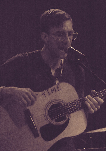 a young man playing guitar