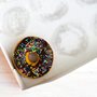 a chocolate and sprinkle covered donut in a box