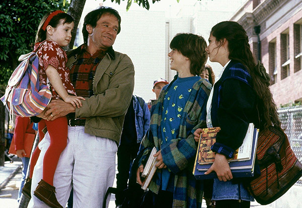 a father laughing with his three children