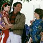 a father laughing with two children