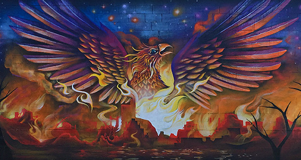 mural of a phoenix rising from a city on fire