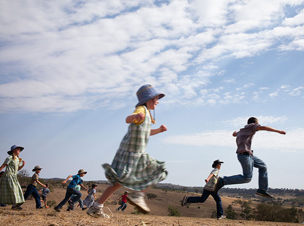 Children running across a field
