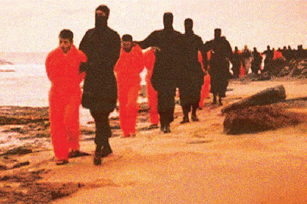 The 21 Coptic martyrs led by their captors along a beach