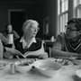 Dorothy Day sharing meal with volunteers