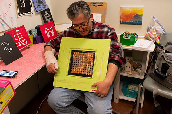 a man showing his artwork