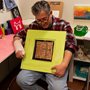 a man showing his artwork