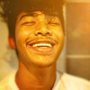 a man smiling with his eyes closed
