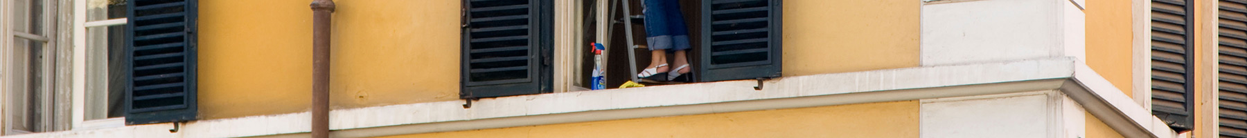 a woman cleaning her apartment windows