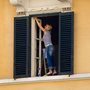 a woman cleaning her apartment windows