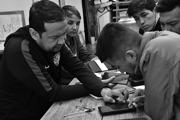 a man teaching English to other men