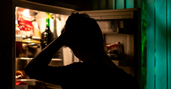 a man looking in a fridge