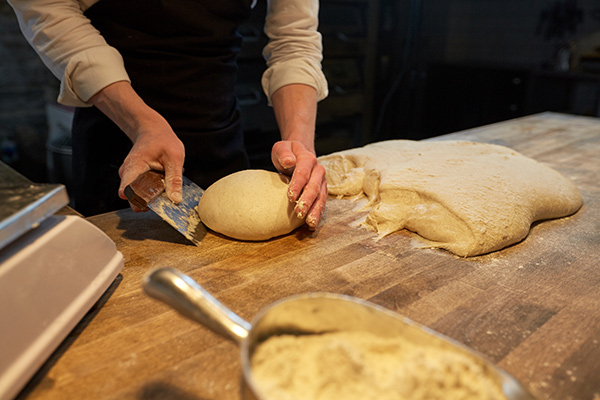 a woman shaping dough