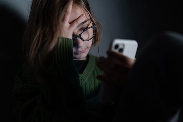 a young girl looking at her phone