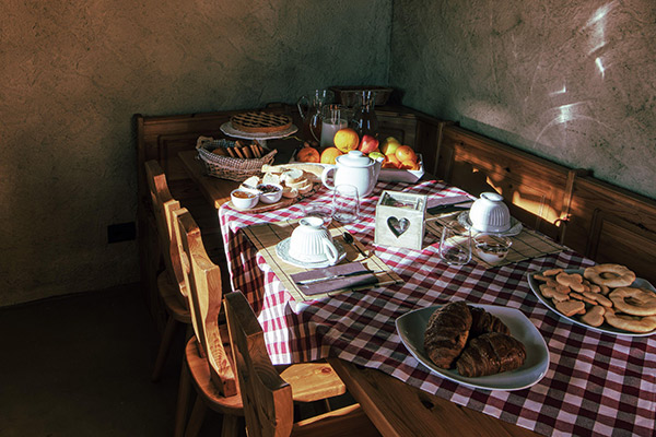 a table with plates of delicious breakfast food