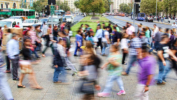 Blurred photograph of people walking on a crowded street