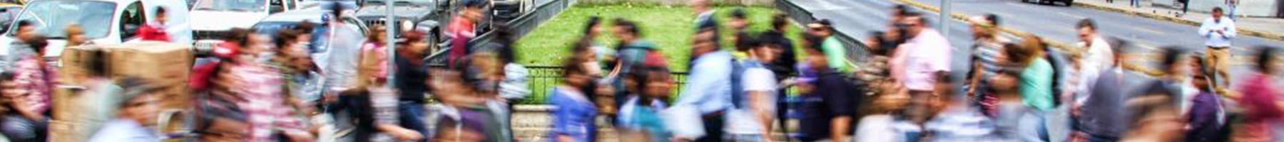 Blurred photograph of people walking on a crowded street