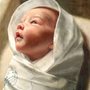 painting of Baby Jesus lying in a manger