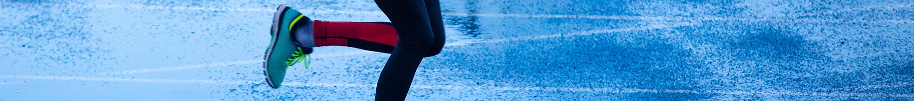 a woman running on wet pavement