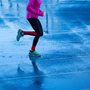 a woman running on wet pavement