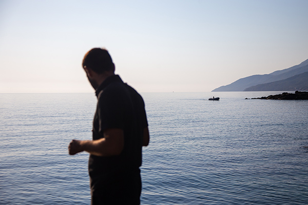 a man standing by the ocean