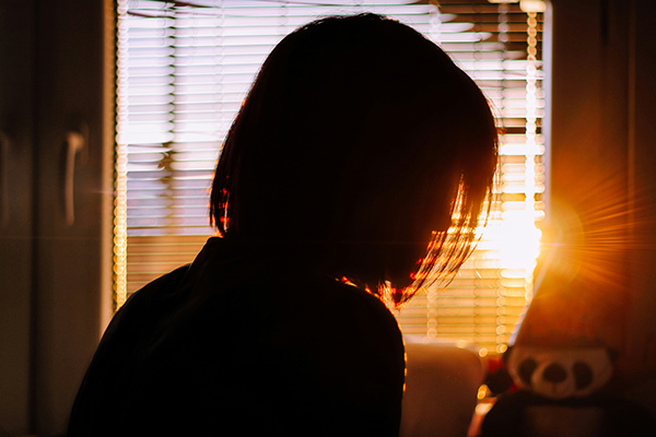 silhouette of woman by a window