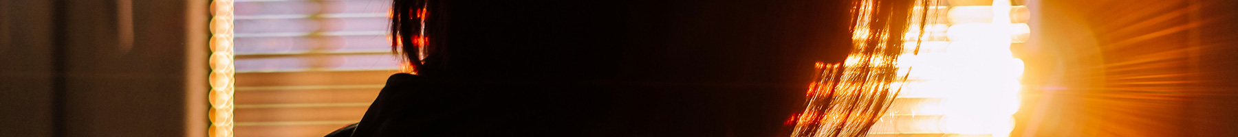 silhouette of woman by a window