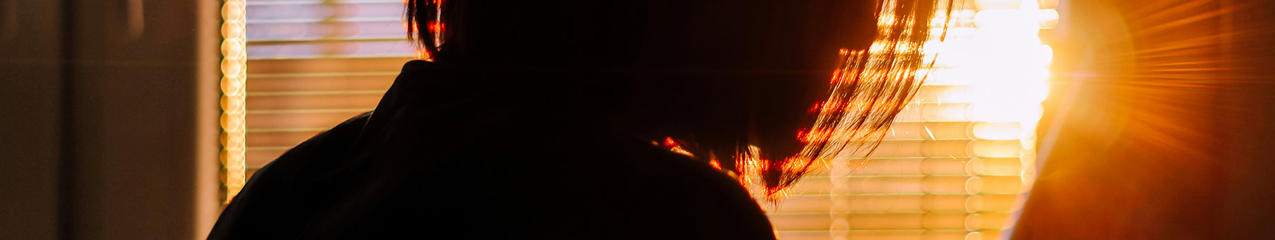 silhouette of woman by a window