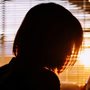 silhouette of woman by a window