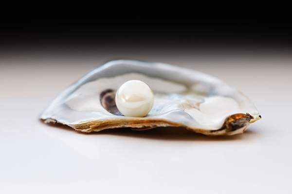Studio photo of pearl in oyster