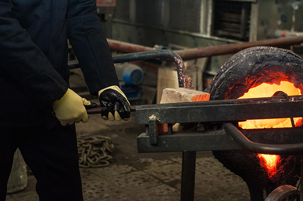 a man working in a metal melting factory