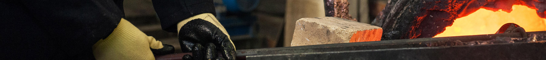 a man working in a metal melting factory