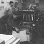 people working in a Plough print shop