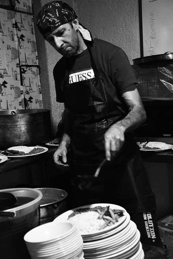 a man cooking food at a stove