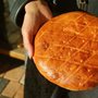 a woman holding an Armenian pastry