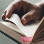 Young man opening and reading a book