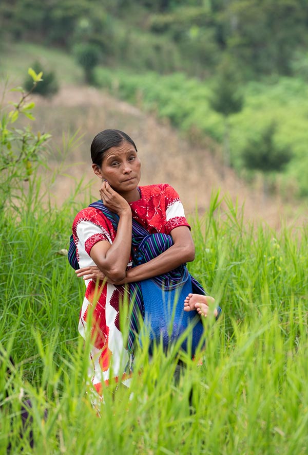 a woman standing in a grassy field