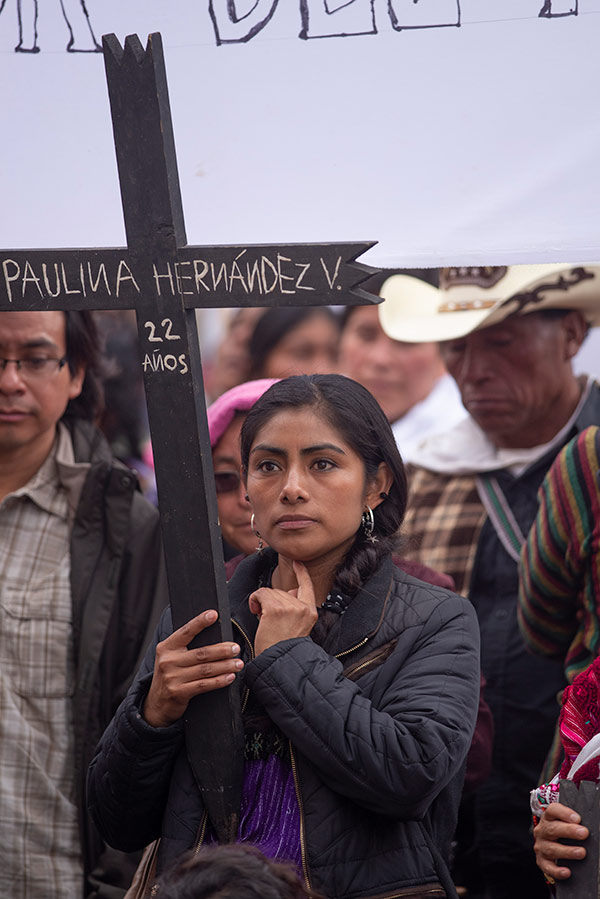 a woman carrying a cross