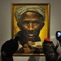 people looking at a painting in a museum
