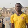 a man standing in a refugee camp