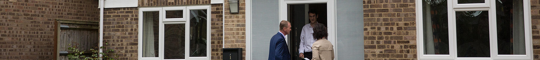 politicians talking to a man on his doorstep