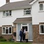 politicians talking to a man on his doorstep