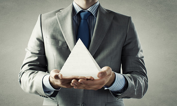 a man holding a white pyramid