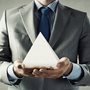 a man holding a white pyramid
