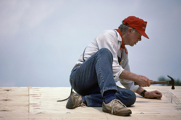 Jimmy Carter roofing a house