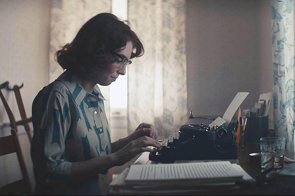 a woman typing on a typewriter