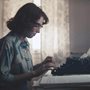 a woman typing on a typewriter