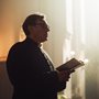 a priest holding a book