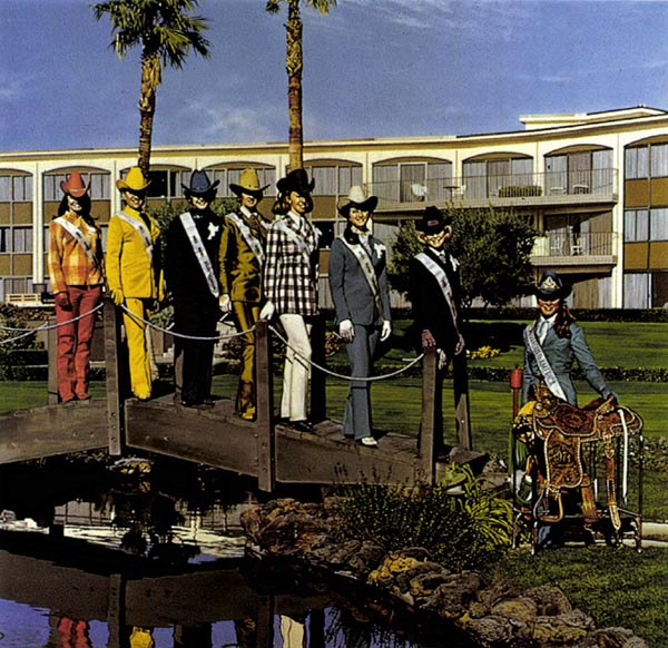 women posing in front of a hotel