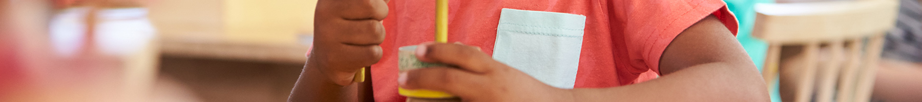 a boy playing with blocks in a Montessori classroom